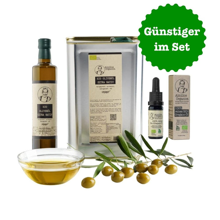 Aimilios Organics 3L Kanister und 500ml Flasche griechisches sortenreines Bio Olivenöl und 10ml Flasche ätherisches bio Oregano Öl auf weissem Hintergrund mit Oliven und Olivenöl als Deko im Vordergrund